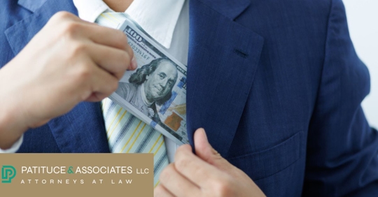 Close-up of businessman taking bribes by hiding money