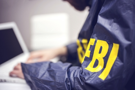 FBI agent working on a laptop