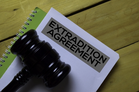 extradition agreement on notebook under a gavel