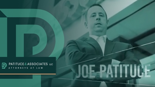 Joe Patituce standing outside with his arms folded